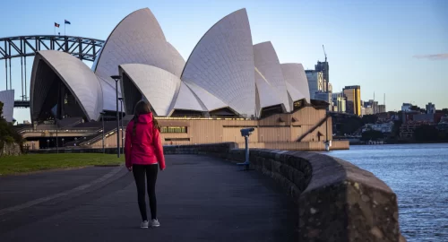 beautiful-girl-walks-by-famous-sydney-opera-house-at-sunrise-sunrise-over-sydney-opera-house-aus