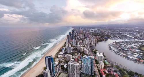 bird-s-eye-view-of-gold-coast-city-skyline-and-ocean-at-sunset
